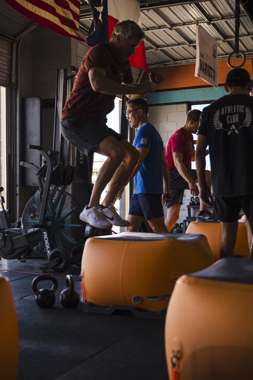 Athlete box jumping on the cube